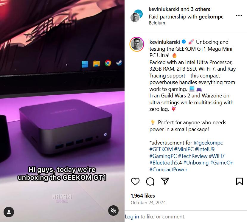 A small purple GEEKOM mini PC sits on a desk beneath a monitor with glowing purple ambient lighting.